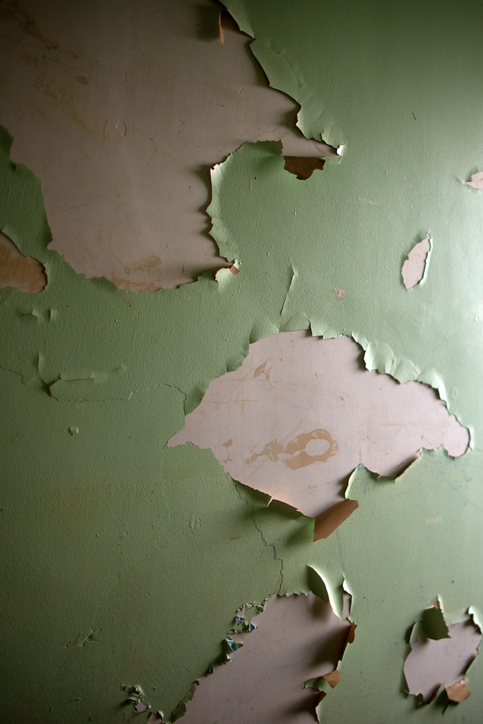 Lead based paint peeling on an old wall.