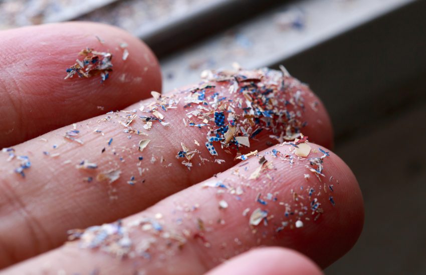 Close up side shot of microplastics lay on people hand.Concept of water pollution and global warming.