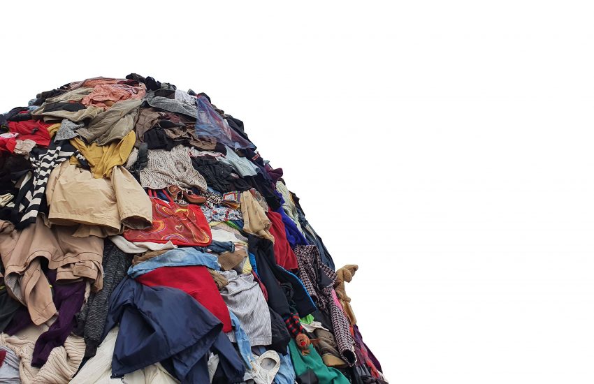 large pile stack of textile fabric clothes and shoes