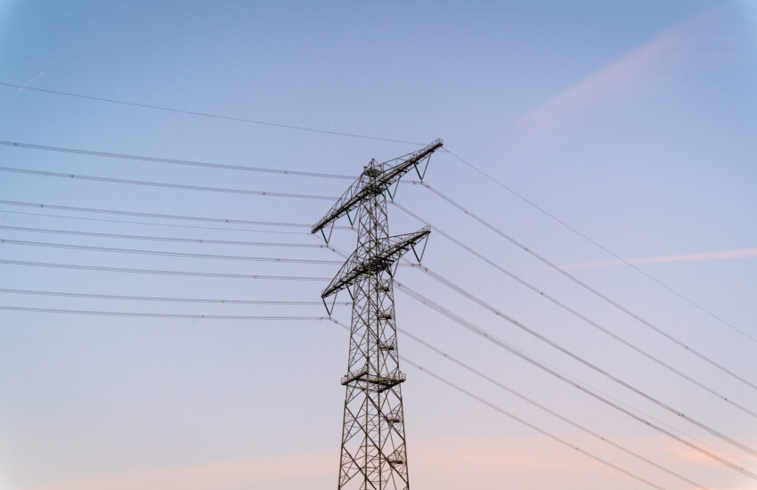 Electricity pylon against pastel sky